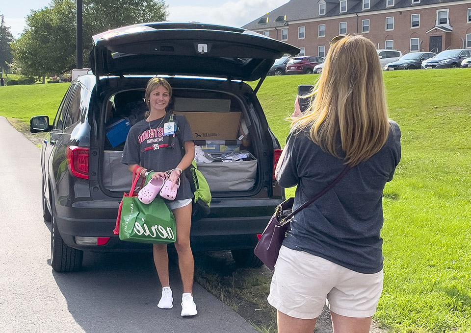 mom photographs daughter on move in day